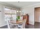 Charming breakfast nook featuring a round table, comfortable seating, and natural light from the window at 4152 Woodward Mill Rd, Sugar Hill, GA 30518