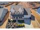 Aerial shot of the home's exterior showcasing the roof, two-car garage, landscaping, and inviting curb appeal at 4152 Woodward Mill Rd, Sugar Hill, GA 30518