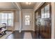 Bright foyer featuring hardwood floors, large barn doors, and natural light, offering a blend of rustic charm and modern style at 4152 Woodward Mill Rd, Sugar Hill, GA 30518