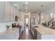 Spacious kitchen featuring gray cabinets, stainless steel appliances, granite countertops, and a large island at 4152 Woodward Mill Rd, Sugar Hill, GA 30518