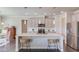 Modern kitchen featuring a large island with seating, stainless steel appliances, and stylish pendant lighting at 4152 Woodward Mill Rd, Sugar Hill, GA 30518