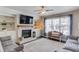 Inviting living room with a fireplace, built-in shelves, and comfortable seating area with a patterned rug at 4152 Woodward Mill Rd, Sugar Hill, GA 30518