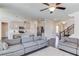 Open-concept living space with a large sofa, kitchen island with barstools, and stairs to the upper level at 4152 Woodward Mill Rd, Sugar Hill, GA 30518