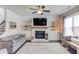 Bright living room showcasing a fireplace, built-in shelving, and a cozy seating arrangement with natural light at 4152 Woodward Mill Rd, Sugar Hill, GA 30518