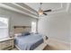 Bedroom featuring a tray ceiling, ceiling fan, and a king-size bed with white linens at 4152 Woodward Mill Rd, Sugar Hill, GA 30518