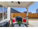 Covered patio featuring comfortable outdoor seating area, a grill, and a wooden fence at 4152 Woodward Mill Rd, Sugar Hill, GA 30518
