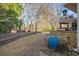 Spacious backyard is surrounded by a natural wooded view and features a stone paver pathway at 2325 Woodcrest Se Dr, Smyrna, GA 30082