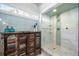 Bathroom featuring a decorative cabinet, tiled walls, and a glass shower at 2325 Woodcrest Se Dr, Smyrna, GA 30082
