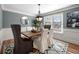 Dining room features neutral colored walls, wainscotting, hardwood floors, and a decorative light fixture at 2325 Woodcrest Se Dr, Smyrna, GA 30082