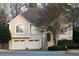 Charming two-story home with a well-manicured lawn, two-car garage, and lush landscaping at 2325 Woodcrest Se Dr, Smyrna, GA 30082