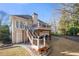 Backyard view featuring tiered deck, outdoor seating, landscaped garden, and natural surroundings for serene outdoor living at 2325 Woodcrest Se Dr, Smyrna, GA 30082