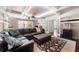 Spacious living room features coffered ceilings, a comfortable leather sectional, and a patterned rug for added elegance at 2325 Woodcrest Se Dr, Smyrna, GA 30082