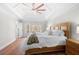Bright main bedroom featuring a bed, hardwood floors, and tray ceilings at 2325 Woodcrest Se Dr, Smyrna, GA 30082