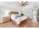 Bright main bedroom featuring a bed, hardwood floors, and tray ceilings at 2325 Woodcrest Se Dr, Smyrna, GA 30082