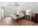 Bright main bedroom with hardwood floors, tray ceilings, and a large window overlooking the outdoors at 2325 Woodcrest Se Dr, Smyrna, GA 30082