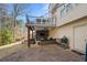 Covered patio features a woven couch, grill, and an outdoor green egg at 2325 Woodcrest Se Dr, Smyrna, GA 30082