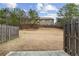 Large fenced-in backyard with dry grass and mature trees in the distance at 2783 Bayrose Cir # 83, Atlanta, GA 30344