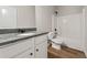 This bathroom features a shower-tub combo, dark granite counters and bronze fixtures at 2783 Bayrose Cir # 83, Atlanta, GA 30344