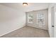 This bedroom has neutral walls, carpet, light and two windows with a view at 2783 Bayrose Cir # 83, Atlanta, GA 30344