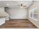 Open floor plan with wood-look floors, staircase, kitchen, and a ceiling fan at 2783 Bayrose Cir # 83, Atlanta, GA 30344
