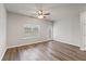 Minimalist living room with light gray walls, wood-look floors, ceiling fan and a door to the outside at 2783 Bayrose Cir # 83, Atlanta, GA 30344