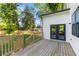 A wood deck featuring access to the home and a staircase leading to the spacious fenced backyard at 61 Newcastle Sw St, Atlanta, GA 30314