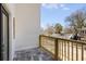 Private balcony with wood railing offering neighborhood views and outdoor living space at 61 Newcastle Sw St, Atlanta, GA 30314