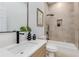 Stylish bathroom featuring neutral tile, floating vanity with black fixtures, tub, and niche for storage at 61 Newcastle Sw St, Atlanta, GA 30314