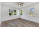 Bright bedroom with three windows, recessed lighting, and wood floors at 61 Newcastle Sw St, Atlanta, GA 30314