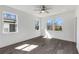 A bright bedroom with hardwood floors, white walls, and a modern ceiling fan showcasing natural light at 61 Newcastle Sw St, Atlanta, GA 30314
