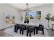 Bright dining room with modern chandelier, a large table, and a door that opens to a deck area at 61 Newcastle Sw St, Atlanta, GA 30314