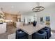 Bright, open-concept kitchen with stainless steel appliances, an island, and dining area with modern chandelier at 61 Newcastle Sw St, Atlanta, GA 30314
