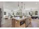 Well-lit, open-concept layout featuring kitchen island, stainless steel appliances, and flow into dining and living areas at 61 Newcastle Sw St, Atlanta, GA 30314