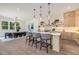 Well-lit open kitchen and dining area with modern fixtures, stainless appliances, and light hardwood flooring throughout at 61 Newcastle Sw St, Atlanta, GA 30314
