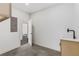 Laundry room with sink, cabinets, tile flooring, and an open door that views a hall way at 61 Newcastle Sw St, Atlanta, GA 30314