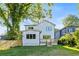 The rear exterior shows a new build with black framed windows, white siding, and a wooden deck at 61 Newcastle Sw St, Atlanta, GA 30314