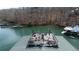 Scenic aerial view of a waterfront property with a sundeck and private dock on a tranquil lake at 6880 Nantucket Cv, Cumming, GA 30041