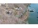 Aerial view of lake house showing proximity to lake and dock, with an easy walk to the dock at 6880 Nantucket Cv, Cumming, GA 30041