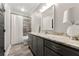 Modern bathroom with gray cabinets, granite countertops, tiled floors, and walk-in shower at 6880 Nantucket Cv, Cumming, GA 30041
