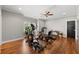 Bright exercise room with wood floors, featuring ceiling fan, exercise equipment and ample space for workouts at 6880 Nantucket Cv, Cumming, GA 30041