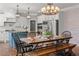 Bright eat-in kitchen boasts stainless appliances, a kitchen island and custom decorative lighting at 6880 Nantucket Cv, Cumming, GA 30041