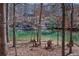 Scenic lake view featuring two Adirondack chairs and a private dock, perfect for enjoying waterfront living at 6880 Nantucket Cv, Cumming, GA 30041