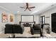 Cozy movie room with plush seating, a ceiling fan, and a large screen for viewing entertainment at 6880 Nantucket Cv, Cumming, GA 30041