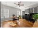 Bright office space with hardwood floors, natural light, ceiling fan, and custom built-in shelving, perfect for working from home at 6880 Nantucket Cv, Cumming, GA 30041