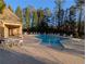 Community pool area with lounge chairs, tables and a covered patio for residents to enjoy in the summer at 6880 Nantucket Cv, Cumming, GA 30041