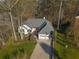 Aerial view of a well-maintained home with a two-car garage and mature trees at 1190 Saint Ives Ct, Suwanee, GA 30024