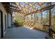 Large back deck with pergola overlooking wooded area and stairs to the backyard at 1190 Saint Ives Ct, Suwanee, GA 30024