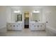 Stylish bathroom featuring a double sink vanity, black fixtures, and a walk-in closet at 1190 Saint Ives Ct, Suwanee, GA 30024