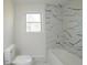 Bathroom featuring marble floors, tile accents, and modern fixtures at 1190 Saint Ives Ct, Suwanee, GA 30024