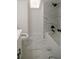 Bathroom featuring a skylight, marble style tile, and modern fixtures at 1190 Saint Ives Ct, Suwanee, GA 30024